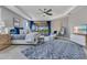 Spacious main bedroom with tray ceilings, ceiling fan, sitting area, and sliding doors to the lanai at 13139 Stanthorne Ave, Orlando, FL 32832
