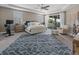 Spacious main bedroom with sitting area, ceiling fan, and balcony access at 13139 Stanthorne Ave, Orlando, FL 32832