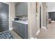Mudroom area with gray cabinetry, counter space, and convenient access to the home's interior at 13139 Stanthorne Ave, Orlando, FL 32832