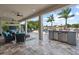 Covered patio with outdoor seating, bar area, ceiling fans, and view of the backyard pool at 13139 Stanthorne Ave, Orlando, FL 32832