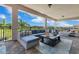 Covered outdoor patio with cozy sectional seating overlooking water views at 13139 Stanthorne Ave, Orlando, FL 32832