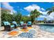 Cozy outdoor seating area with a fire pit, perfect for enjoying evenings by the pool at 13139 Stanthorne Ave, Orlando, FL 32832