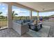 Inviting covered patio with a serene lake view and comfortable outdoor seating at 13139 Stanthorne Ave, Orlando, FL 32832