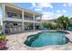 Backyard with refreshing pool, bar area, outdoor kitchen, and second story patio at 13139 Stanthorne Ave, Orlando, FL 32832