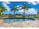 Beautiful outdoor pool with mature palm trees and a fence around the backyard at 13139 Stanthorne Ave, Orlando, FL 32832