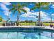 Beautiful pool with built in seating and a view of the green and tropical landscaping at 13139 Stanthorne Ave, Orlando, FL 32832