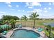 Backyard pool area with palm trees, comfortable seating, and views of the lush community at 13139 Stanthorne Ave, Orlando, FL 32832