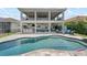 Spacious backyard featuring a large pool and a covered outdoor living area with a bar at 13139 Stanthorne Ave, Orlando, FL 32832