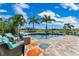 Backyard oasis with a pool surrounded by lounge seating, palm trees, and a fire pit at 13139 Stanthorne Ave, Orlando, FL 32832