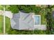Aerial view of the property showcasing the roof, pool, yard, and surrounding greenery at 1330 W Harvard St, Orlando, FL 32804