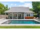 A well-maintained backyard featuring a sparkling pool, outdoor seating, and manicured landscaping at 1330 W Harvard St, Orlando, FL 32804