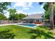 Spacious backyard with a private pool, lush green lawn, mature trees, and a patio area at 1330 W Harvard St, Orlando, FL 32804