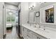 Bathroom showcasing double sink vanity, quartz counters, and view to the bedroom and walk-in closet at 1330 W Harvard St, Orlando, FL 32804