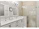 Bathroom featuring a double sink vanity with quartz counters, and a glass-enclosed shower at 1330 W Harvard St, Orlando, FL 32804