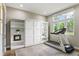 Versatile room featuring a Murphy bed, built-in shelving, and a treadmill by the window at 1330 W Harvard St, Orlando, FL 32804