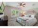 Bedroom featuring a plush upholstered headboard, ceiling fan, and ample natural light from the window at 1330 W Harvard St, Orlando, FL 32804