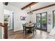 Bright dining room with wood beams, stylish lighting, and view of pool and patio at 1330 W Harvard St, Orlando, FL 32804