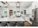 Spacious kitchen with stainless steel appliances, a central island with bar seating, and white cabinets at 1330 W Harvard St, Orlando, FL 32804