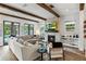 Open-concept living room with wood beams, fireplace, and view to pool and patio at 1330 W Harvard St, Orlando, FL 32804