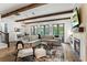 Inviting living room featuring a fireplace, wood beams, and comfortable seating at 1330 W Harvard St, Orlando, FL 32804