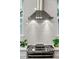 Close up of modern stainless steel range and hood with stylish white subway tile backsplash at 1330 W Harvard St, Orlando, FL 32804