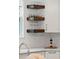 Close up of open wooden kitchen shelving showing glassware next to white kitchen cabinets at 1330 W Harvard St, Orlando, FL 32804