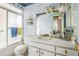 Bathroom with patterned wallpaper, shower, vanity and ornate gold accents at 1354 S Shore Dr, St Cloud, FL 34771