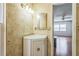 Bathroom with patterned walls, white vanity and adjacent view of living area at 1354 S Shore Dr, St Cloud, FL 34771