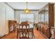 Dining room with hardwood floors, built-in storage, and a decorative light fixture at 1354 S Shore Dr, St Cloud, FL 34771