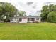 Exterior view of house with well maintained lawn and landscaping at 1354 S Shore Dr, St Cloud, FL 34771