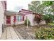 Inviting front entrance with a tiled walkway and colorful landscaping around the home at 1354 S Shore Dr, St Cloud, FL 34771