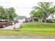 Charming single-story home with a well-maintained lawn and mature trees providing ample shade at 1354 S Shore Dr, St Cloud, FL 34771
