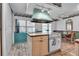 Cozy kitchen with an island cooktop, white cabinetry, and breakfast table at 1354 S Shore Dr, St Cloud, FL 34771