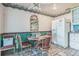 Eat-in kitchen featuring tiled floor, white appliances, and breakfast table at 1354 S Shore Dr, St Cloud, FL 34771