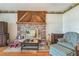 Comfortable living room with a decorative brick fireplace, hardwood floors, and vintage furniture at 1354 S Shore Dr, St Cloud, FL 34771