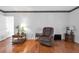 Cozy living room featuring hardwood floors, chair, and classic decor at 1354 S Shore Dr, St Cloud, FL 34771
