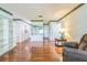 Bright living room with hardwood floors, built-in bookshelves, and a view of the front entrance at 1354 S Shore Dr, St Cloud, FL 34771