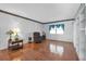 Bright living room with hardwood floors, chair, and large window with elegant curtains at 1354 S Shore Dr, St Cloud, FL 34771