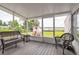 Covered porch featuring wicker chairs and beautiful lake views at 1354 S Shore Dr, St Cloud, FL 34771