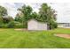 Lattice accent shed in landscaped backyard with lush greenery and view of lake and dock at 1354 S Shore Dr, St Cloud, FL 34771