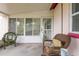 Enclosed sunroom with screened windows, comfortable seating, and a relaxing atmosphere at 1354 S Shore Dr, St Cloud, FL 34771