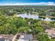 Aerial view showcases the house, the trees, the neighborhood and a nearby lake at 1414 Beaver Pl, Orlando, FL 32806
