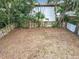 Large backyard featuring a wooden fence, mature trees, and lush greenery at 1414 Beaver Pl, Orlando, FL 32806