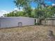 Large backyard with mature trees and a wooden fence at 1414 Beaver Pl, Orlando, FL 32806