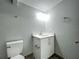 Bathroom featuring a white toilet and vanity with sink and bright lighting at 1414 Beaver Pl, Orlando, FL 32806