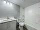 Bathroom featuring a tiled tub, shower, white vanity, and sink with bright lighting at 1414 Beaver Pl, Orlando, FL 32806