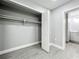 Bedroom features neutral paint, closet with shelving and wood-look tile floors at 1414 Beaver Pl, Orlando, FL 32806
