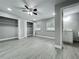 Bedroom featuring two windows, two closets, ceiling fan, and gray wood-look flooring at 1414 Beaver Pl, Orlando, FL 32806