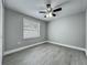 Bright bedroom boasts neutral paint, wood-look flooring, a ceiling fan, and plenty of natural light at 1414 Beaver Pl, Orlando, FL 32806