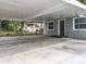 Covered parking area provides shelter and leads to the inviting entrance of this quaint single-story home at 1414 Beaver Pl, Orlando, FL 32806